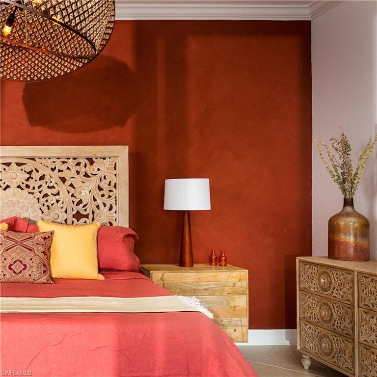 982 Tivoli Court Naples, FL 34104 - Photo 23 of 40 a bedroom with a bed and a lamp on the dresser