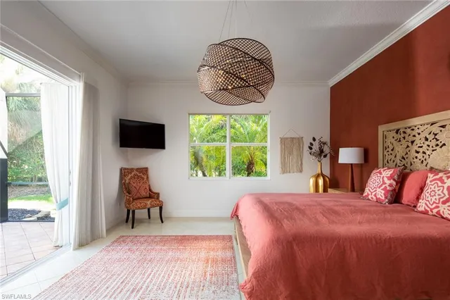 a bedroom with a bed and a mirror