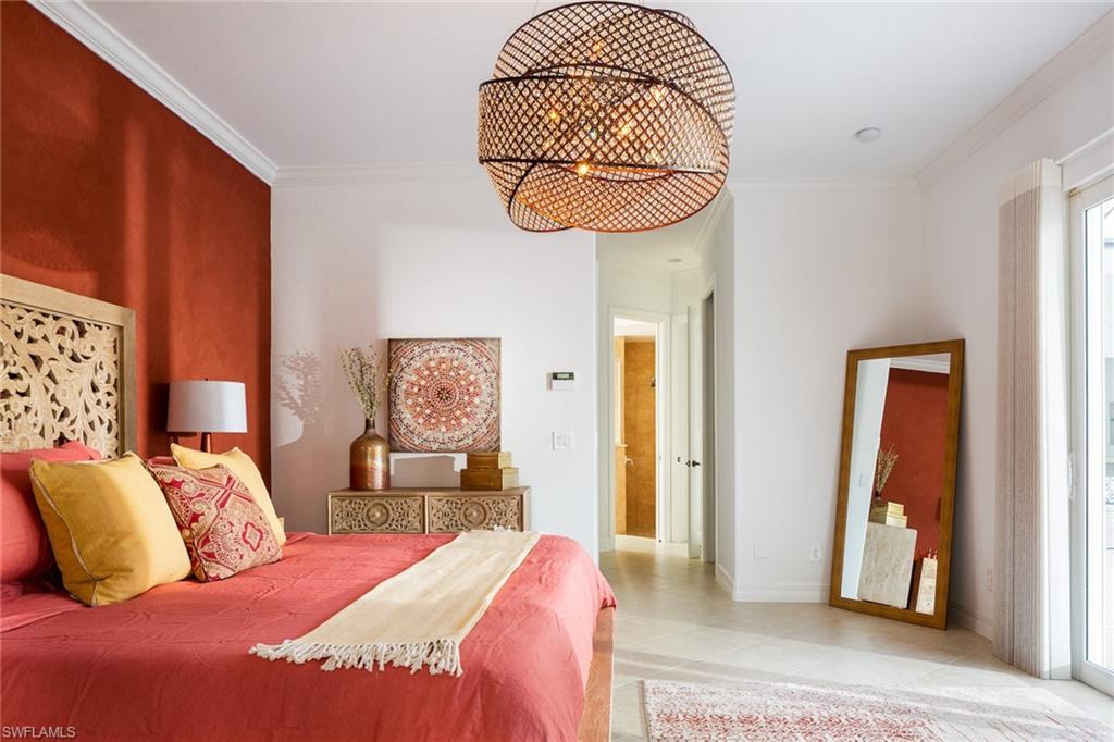 982 Tivoli Court Naples, FL 34104 - Photo 26 of 40 a bedroom with a bed and a mirror