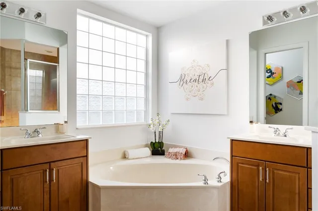 a bathroom with a bathtub sink and mirror