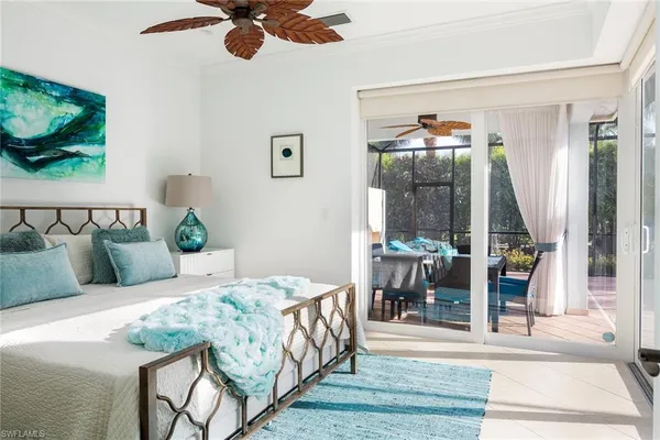 a bedroom with furniture and a large window