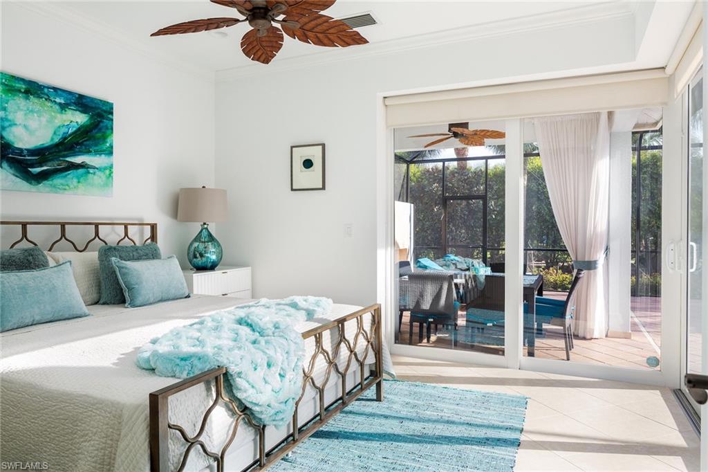 982 Tivoli Court Naples, FL 34104 - Photo 29 of 40 a bedroom with a bed and a mirror