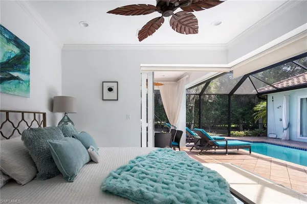 a bed room with a bed and a painting on the wall