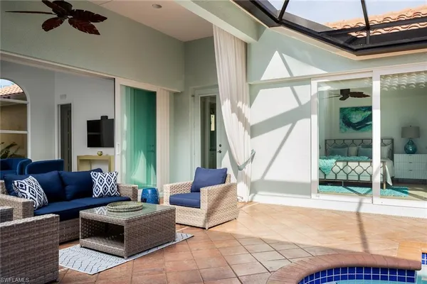 a living room with furniture and a floor to ceiling window