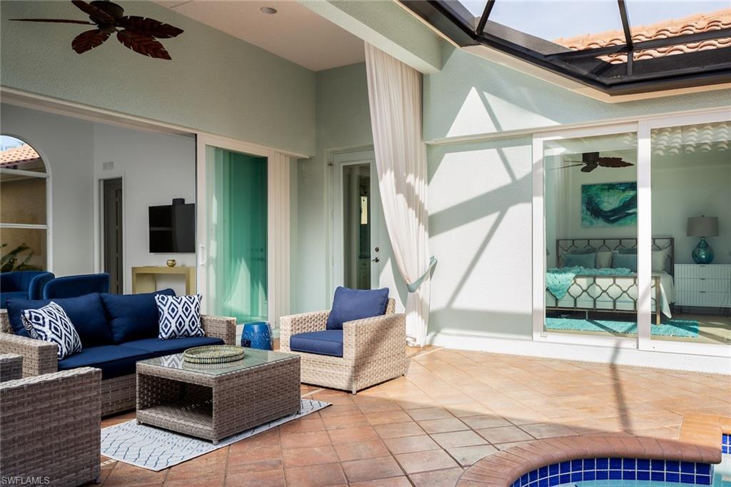 982 Tivoli Court Naples, FL 34104 - Photo 3 of 40 a living room with furniture and a floor to ceiling window