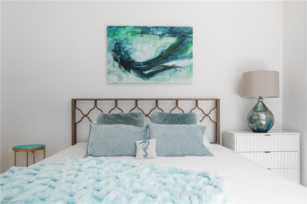 982 Tivoli Court Naples, FL 34104 - Photo 31 of 40 a bed room with a bed and a painting on the wall