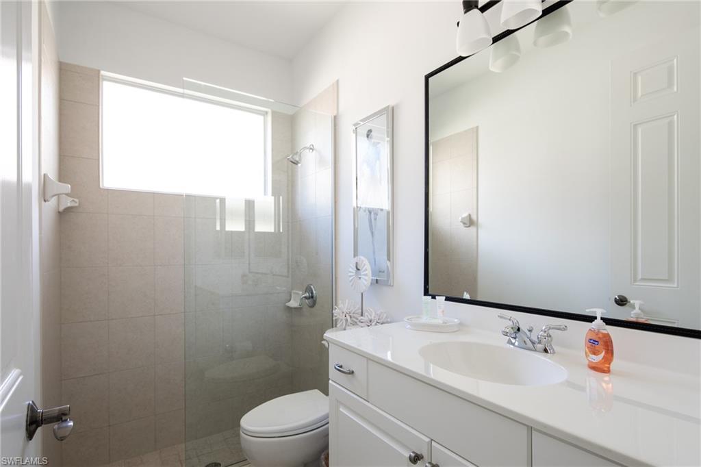982 Tivoli Court Naples, FL 34104 - Photo 32 of 40 a bathroom with a sink a toilet and shower
