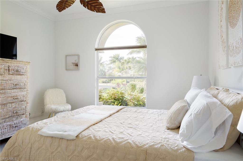 982 Tivoli Court Naples, FL 34104 - Photo 36 of 40 a bedroom with a bed and a flat screen tv