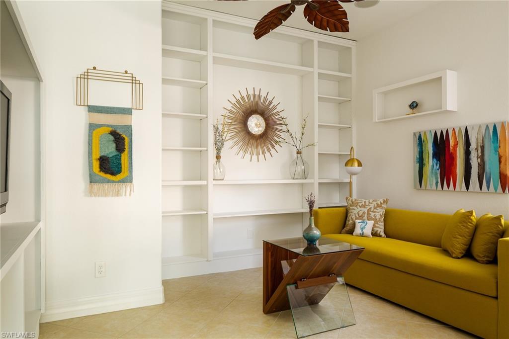 982 Tivoli Court Naples, FL 34104 - Photo 39 of 40 a living room with a couch and a walk in closet
