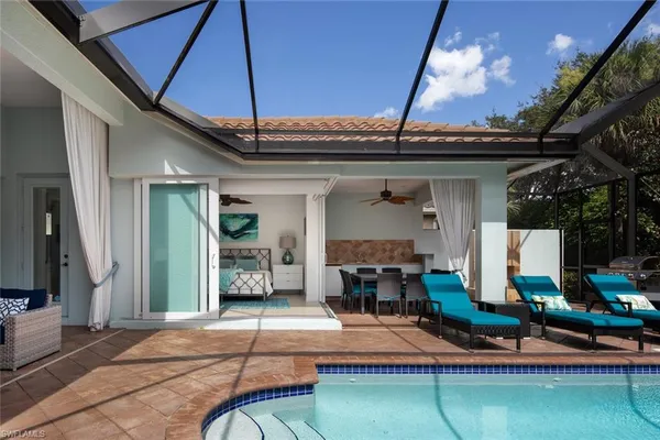 a view of a patio with table and chairs with wooden floor and fence