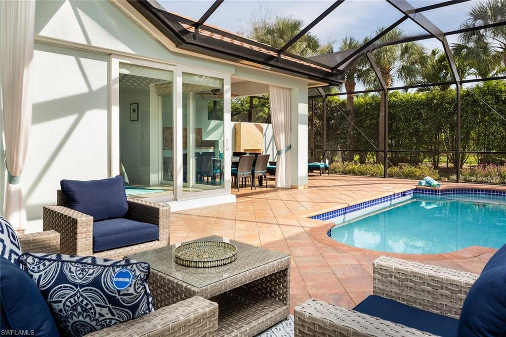 982 Tivoli Court Naples, FL 34104 - Photo 6 of 40 a outdoor living space with furniture and a garden