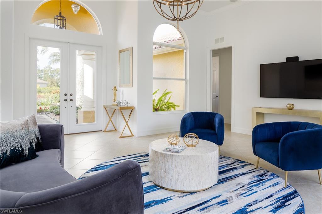 982 Tivoli Court Naples, FL 34104 - Photo 9 of 40 a living room with furniture and a flat screen tv