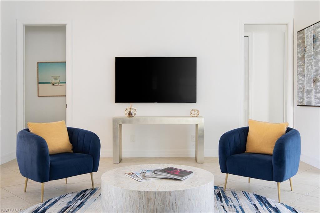 982 Tivoli Court Naples, FL 34104 - Photo 10 of 40 a living room with furniture and a flat screen tv