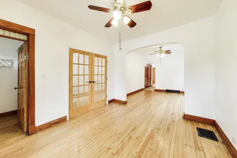 a view of empty room with wooden floor
