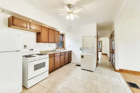 a kitchen with a stove a sink and a refrigerator