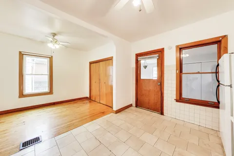 an empty room with windows and closet