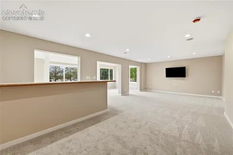 a view of a room with a large window and front door