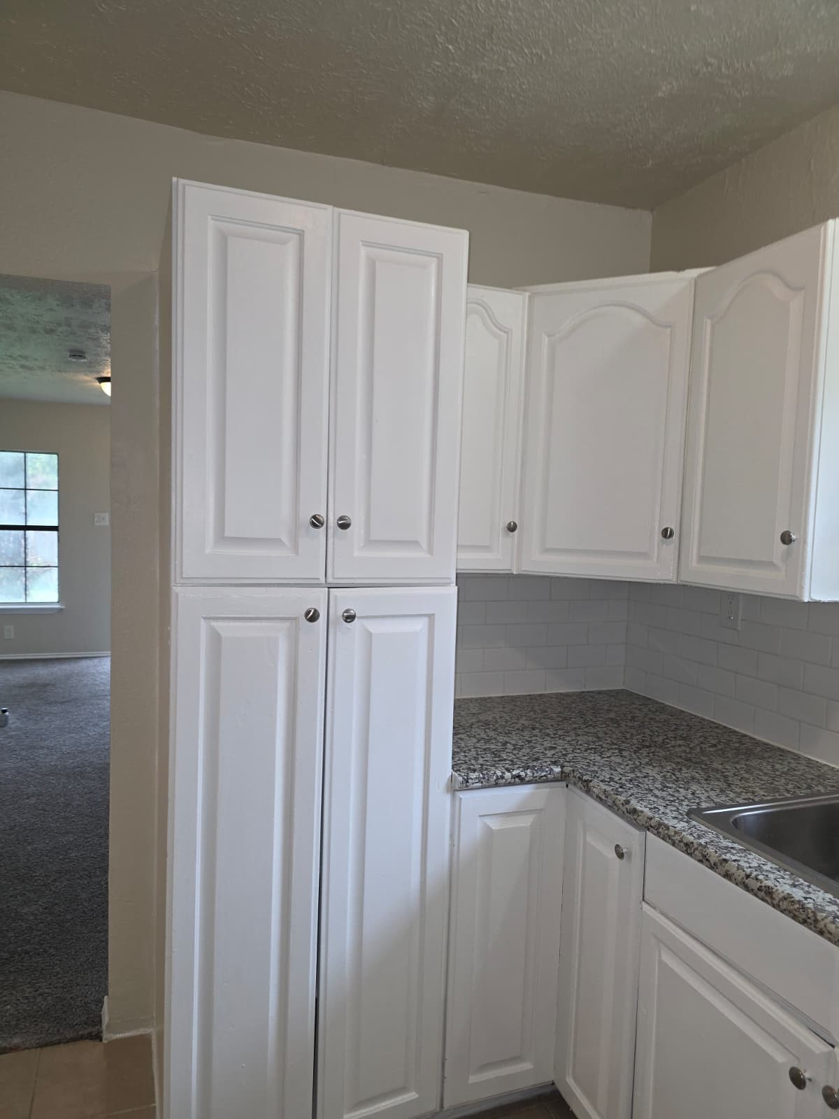 242 Bolden Street Houston, TX 77029 - Photo 12 of 24 a kitchen with granite countertop white cabinets and white appliances