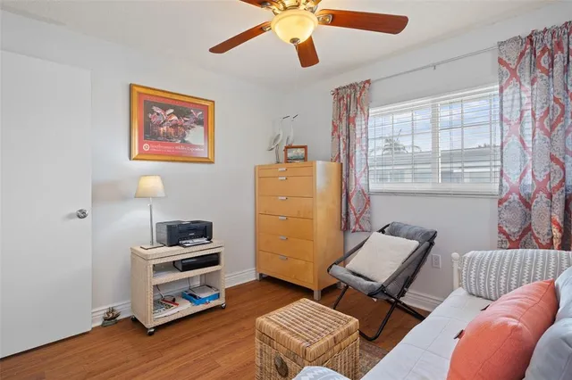 a living room filled with furniture and a potted plant