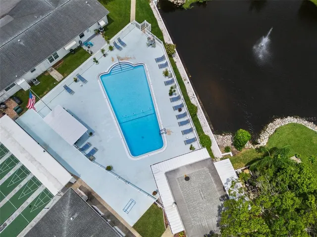 a view of a swimming pool with a yard and seating space