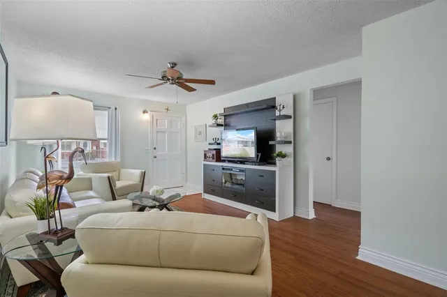 a living room with furniture and wooden floor