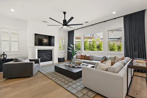a living room with furniture fireplace and a flat screen tv