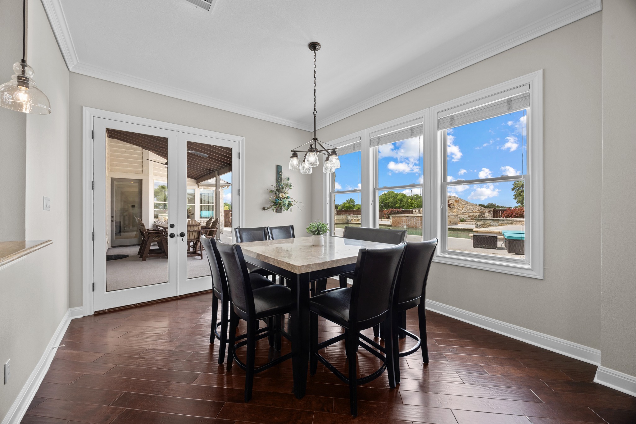 341 Courtnee's Way Georgetown, TX 78626 - Photo 11 of 40 Positioned right off the kitchen, the casual dining area is wrapped in windows that offer a panoramic view of the resort-style backyard.