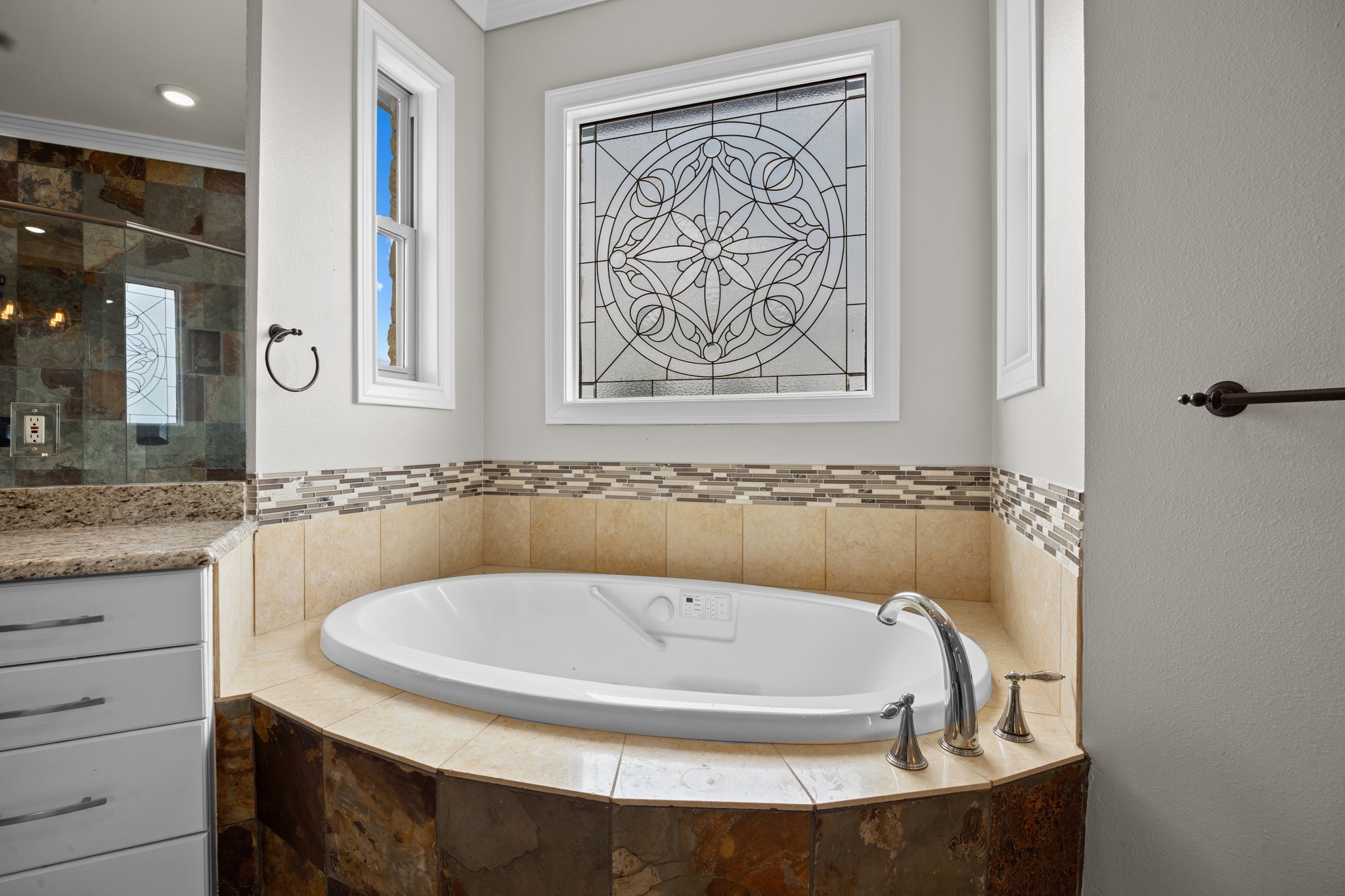 341 Courtnee's Way Georgetown, TX 78626 - Photo 22 of 40 An oversized jetted tub is nestled under a stunning lead-glass privacy window, allowing natural light to filter in.