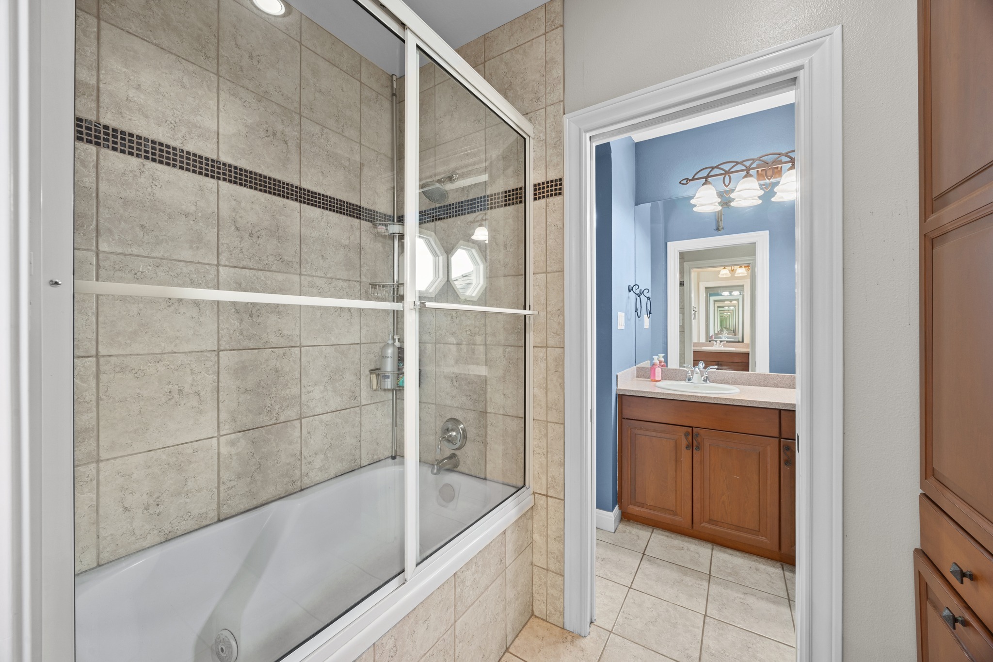 341 Courtnee's Way Georgetown, TX 78626 - Photo 31 of 40 The bathrooms feature warm wood cabinetry, durable countertops and elegant light fixtures.