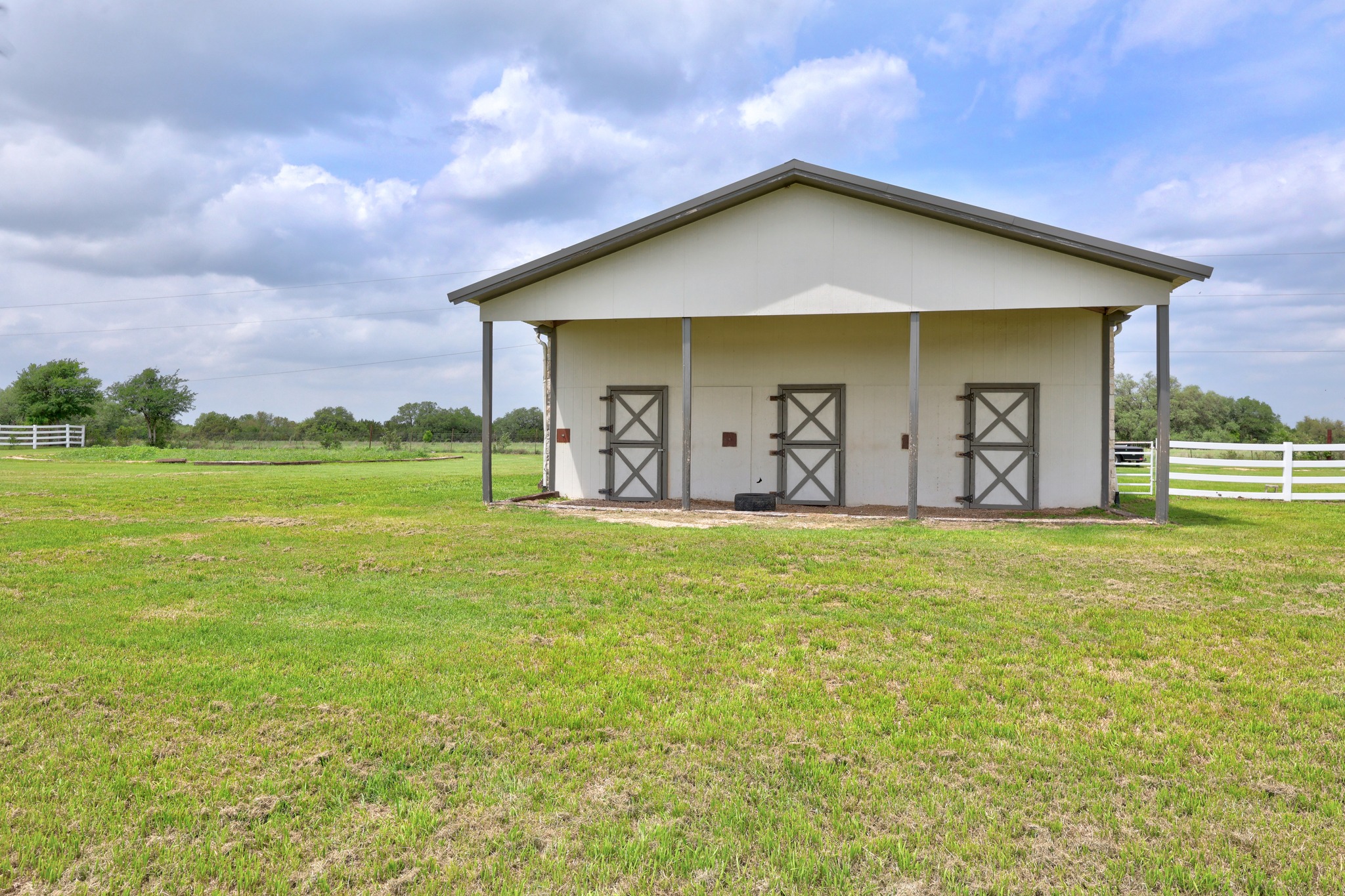 341 Courtnee's Way Georgetown, TX 78626 - Photo 37 of 40 A clean, well-lit three-stall barn provides top-tier housing for your animals, featuring easy-access Dutch doors.