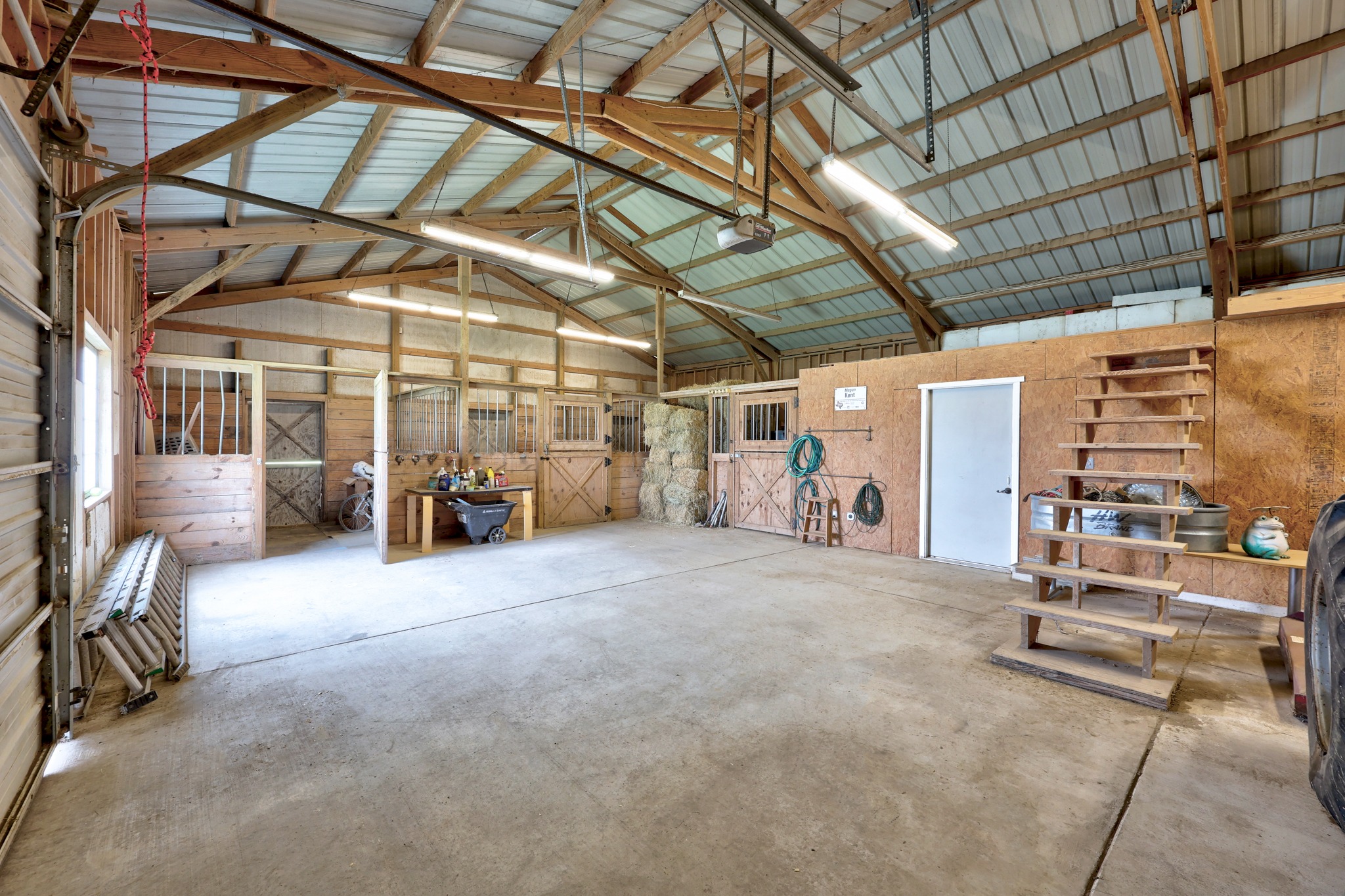 341 Courtnee's Way Georgetown, TX 78626 - Photo 38 of 40 The barn has a storage room, tack room and garage doors that open to store your equipment.