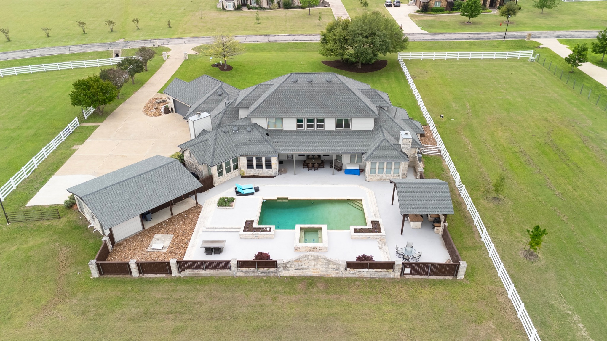 341 Courtnee's Way Georgetown, TX 78626 - Photo 39 of 40 The property is meticulously enclosed with classic white rail fencing, offering vast, level grazing areas and plenty of room to roam.