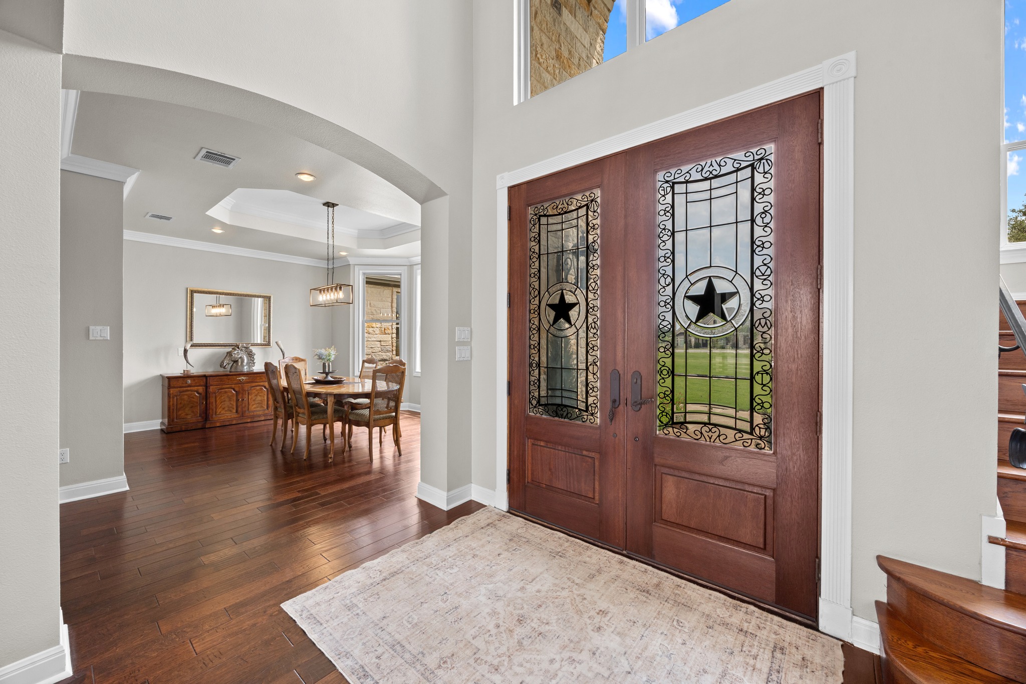 341 Courtnee's Way Georgetown, TX 78626 - Photo 4 of 40 First impressions are everything, and this foyer delivers with a bold Texas flair. Massive double doors featuring intricate wrought-iron star detailing set the tone for the entire residence.