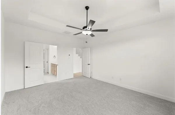 a view of an empty room with a ceiling fan