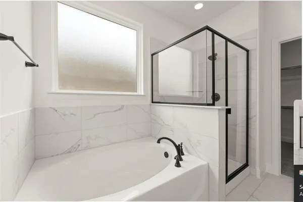 a bathroom with bathtub and shower