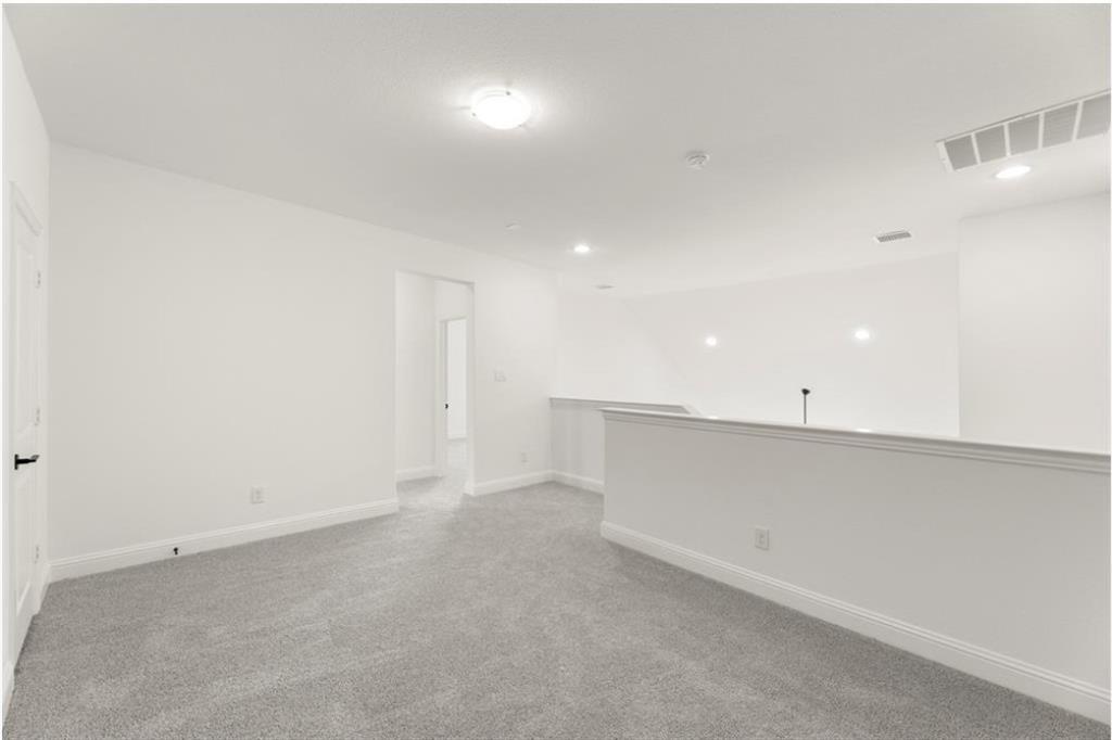 2902 Hanscom Street Forney, TX 75126 - Photo 18 of 28 Empty room with light colored carpet and baseboards