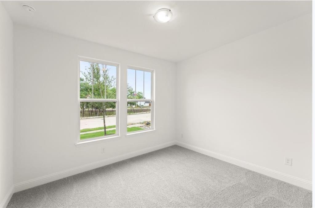 2902 Hanscom Street Forney, TX 75126 - Photo 19 of 28 Empty room featuring light colored carpet and baseboards