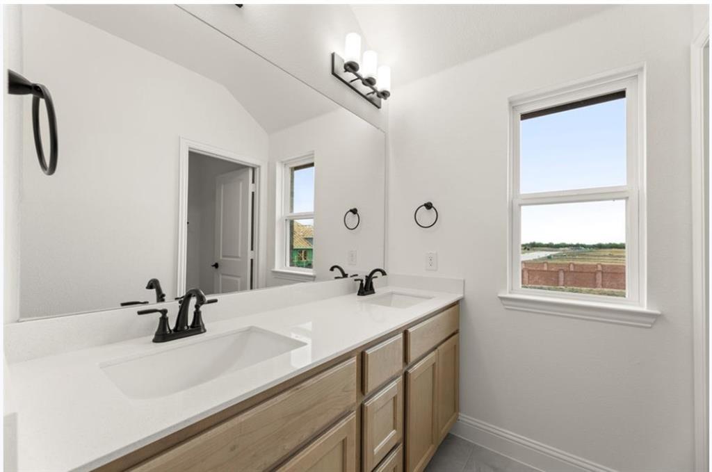 2902 Hanscom Street Forney, TX 75126 - Photo 22 of 28 Bathroom featuring double vanity and vaulted ceiling
