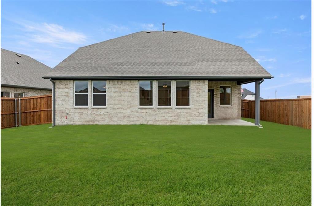 2902 Hanscom Street Forney, TX 75126 - Photo 3 of 28 Rear view of house with a patio area, brick siding, a fenced backyard, and roof with shingles