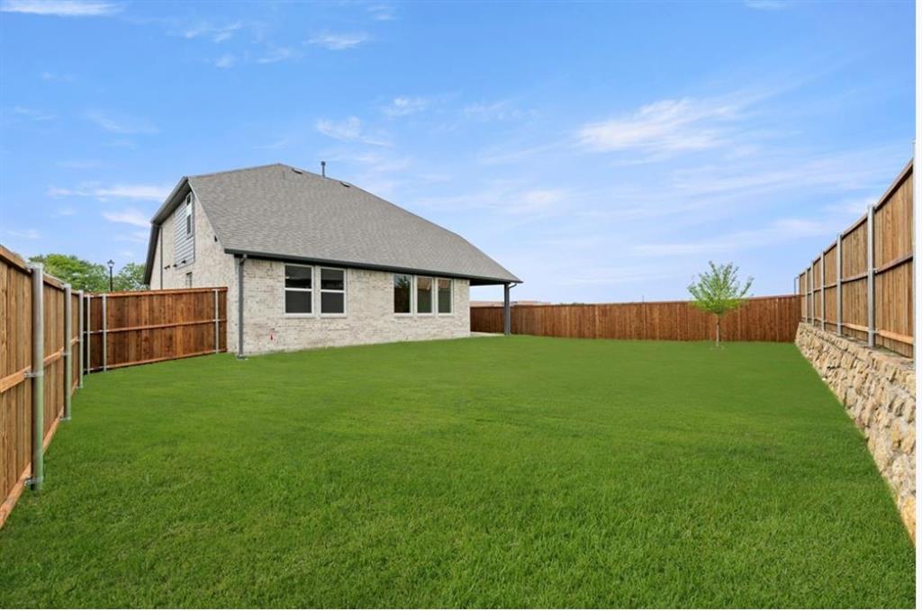 2902 Hanscom Street Forney, TX 75126 - Photo 4 of 28 Rear view of property with a fenced backyard, a shingled roof, and brick siding