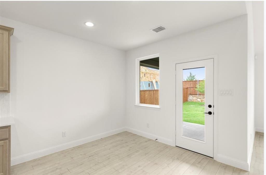 2902 Hanscom Street Forney, TX 75126 - Photo 9 of 28 Doorway to outside with wood finished floors and recessed lighting