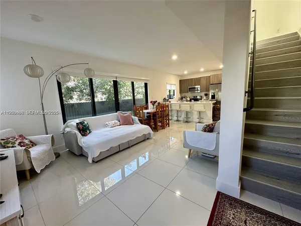 a living room with furniture and a large window