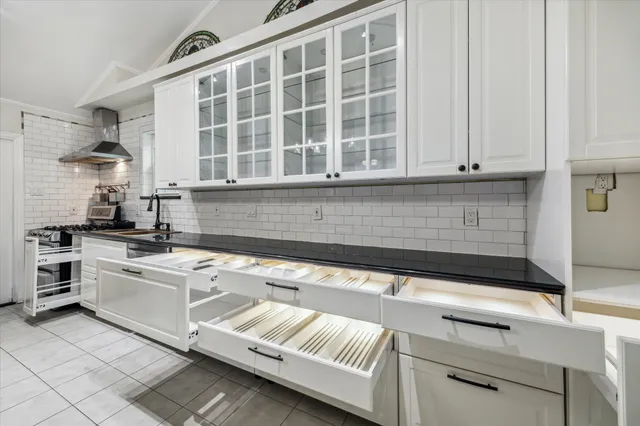 a kitchen with stainless steel appliances granite countertop a sink and cabinets