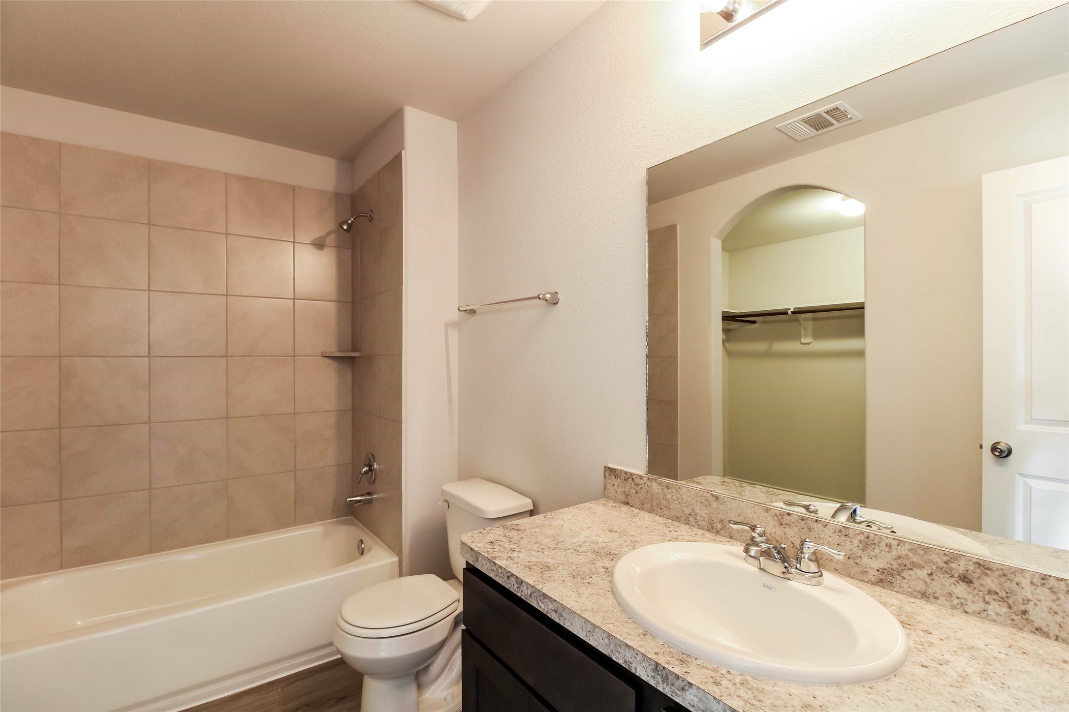 2528 Shad Drive Conroe, TX 77384 - Photo 9 of 16 a bathroom with a granite countertop sink toilet and shower