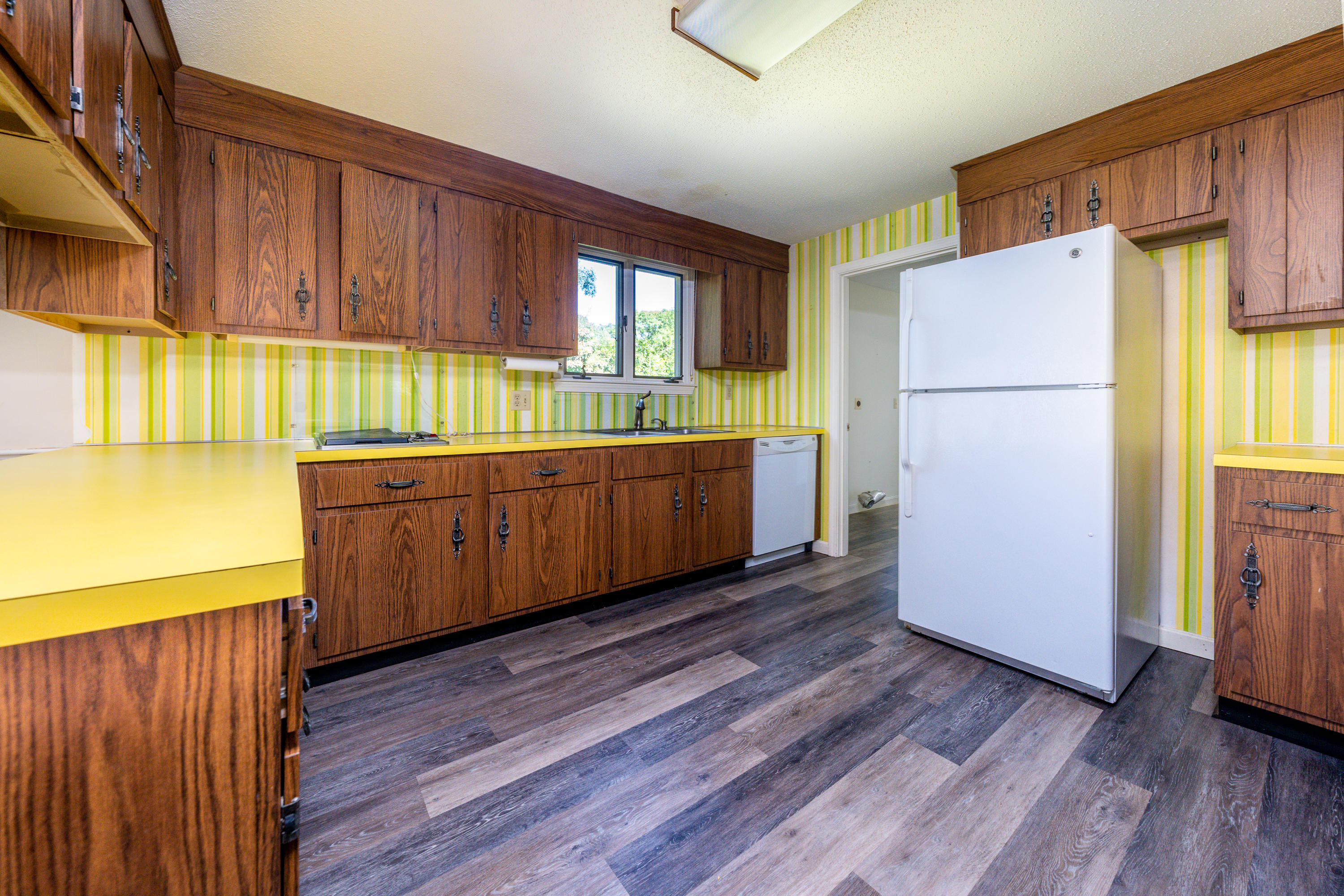 7 Rolling Hitch Road Centerville, MA 02632 - Photo 11 of 19 a kitchen with stainless steel appliances granite countertop a refrigerator a sink dishwasher and wooden cabinets with wooden floor