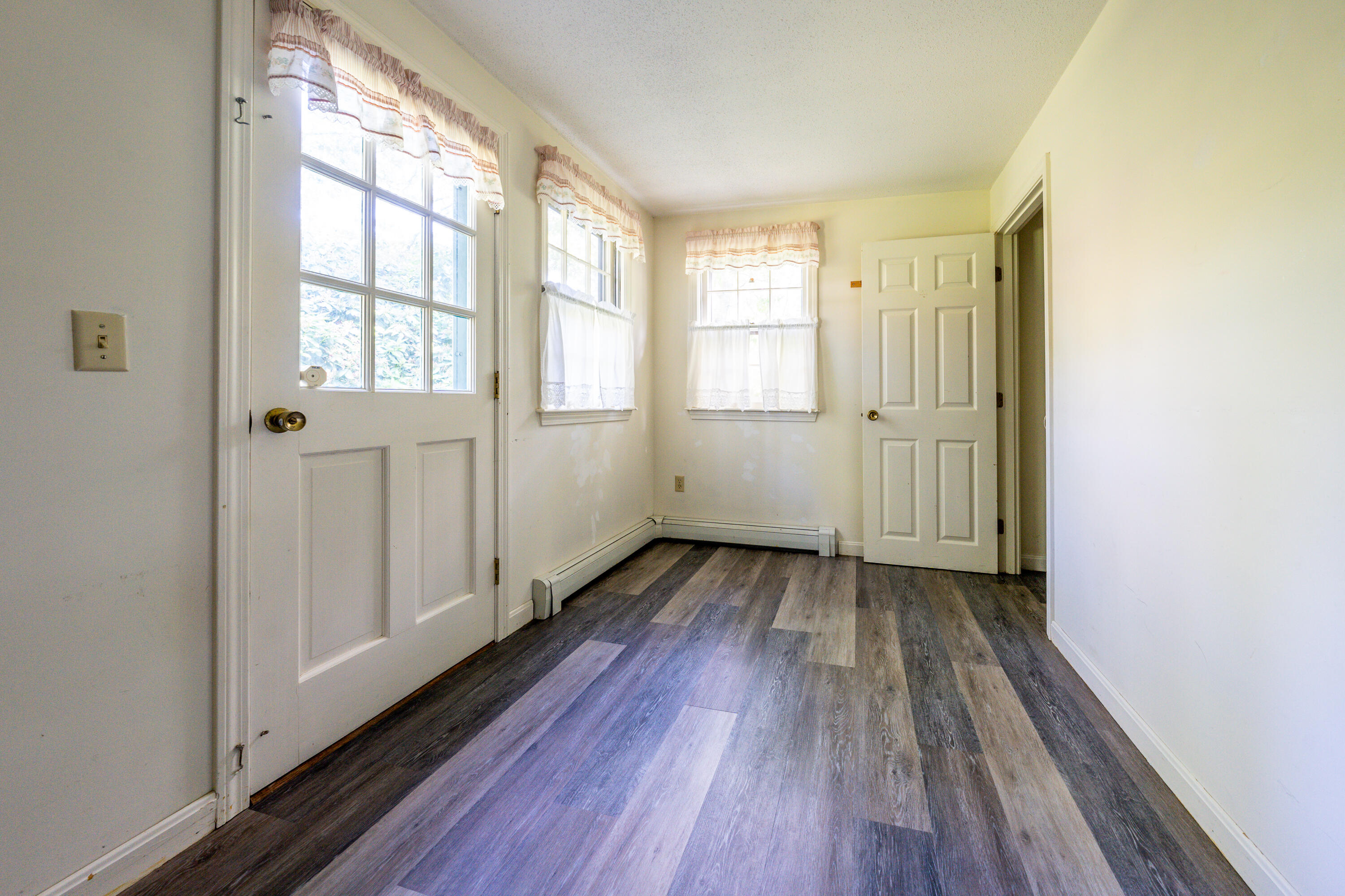 7 Rolling Hitch Road Centerville, MA 02632 - Photo 12 of 19 an empty room with wooden floor and windows