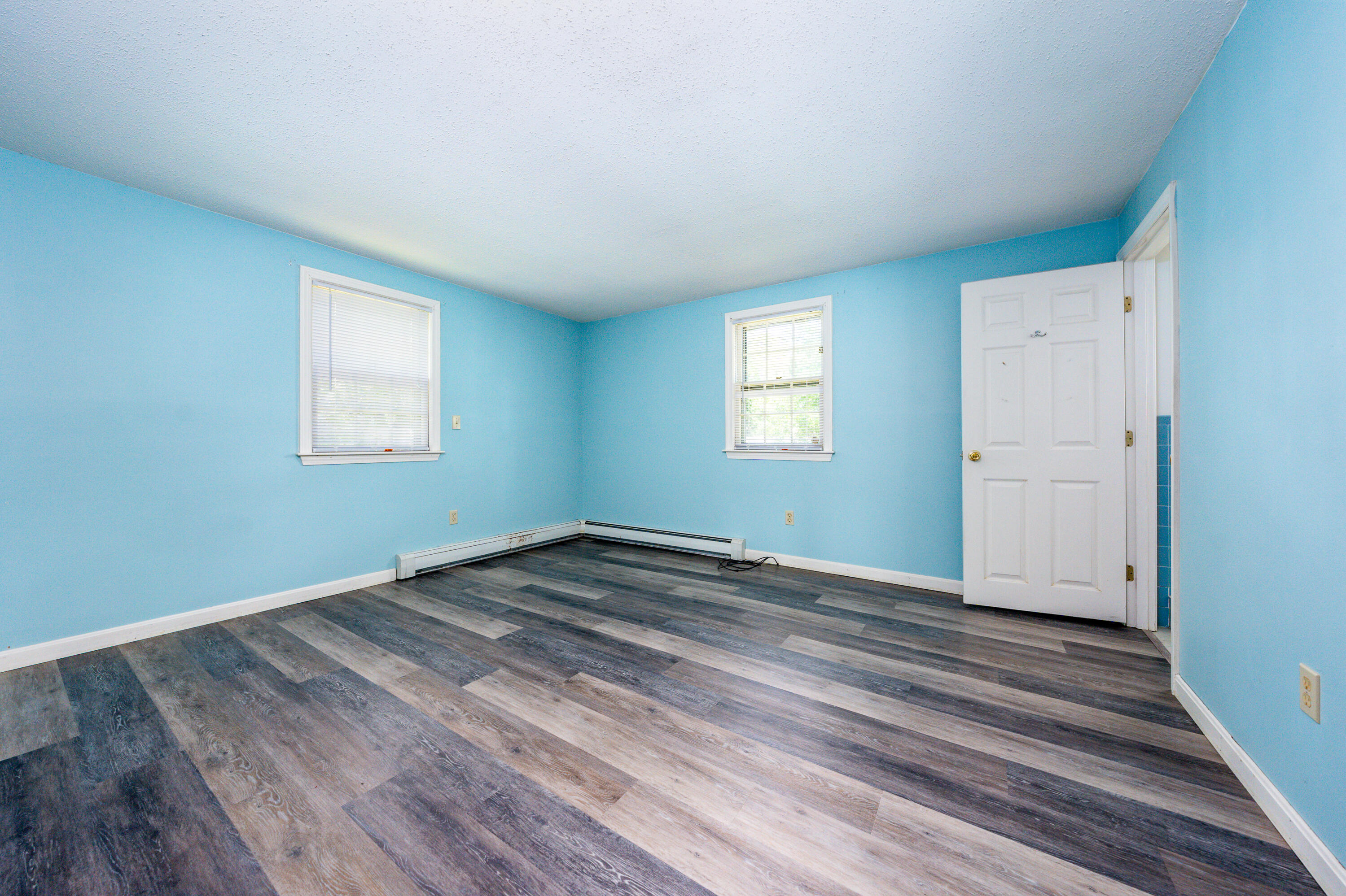 7 Rolling Hitch Road Centerville, MA 02632 - Photo 14 of 19 a view of empty room with wooden floor and fan