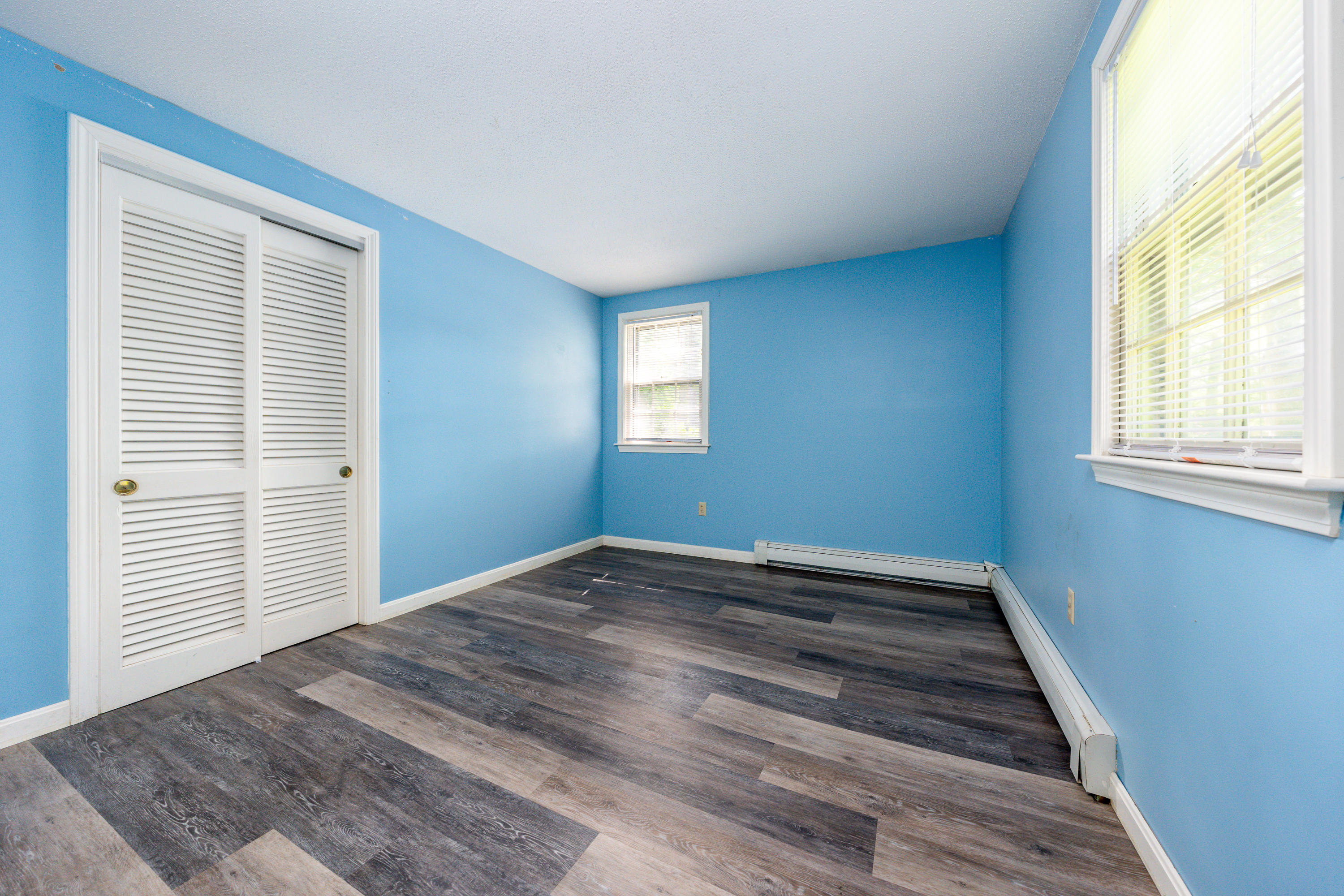 7 Rolling Hitch Road Centerville, MA 02632 - Photo 17 of 19 a view of an empty room with wooden floor and a window