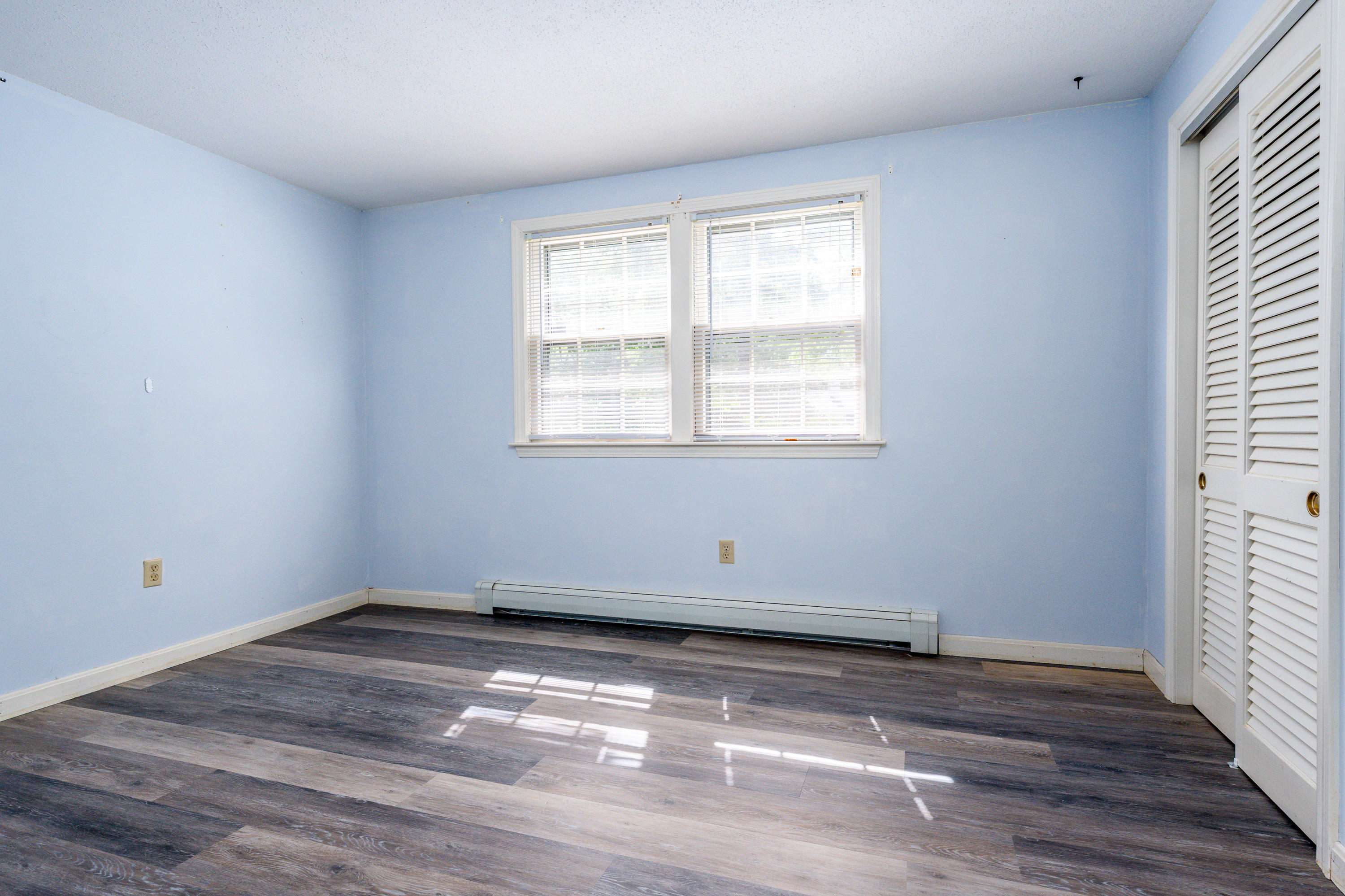7 Rolling Hitch Road Centerville, MA 02632 - Photo 18 of 19 an empty room with wooden floor and windows