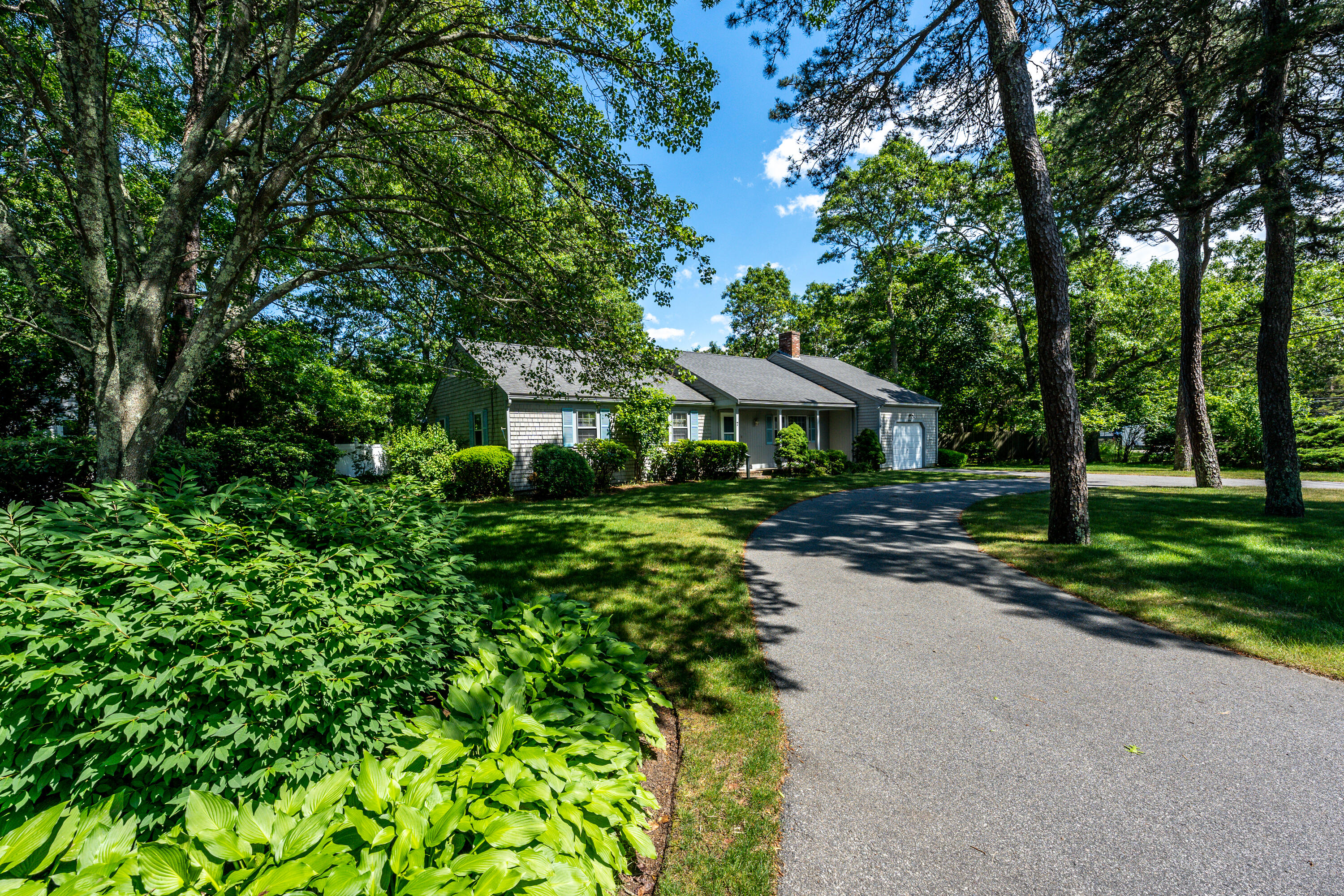7 Rolling Hitch Road Centerville, MA 02632 - Photo 2 of 19 a front view of a house with a yard